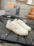 Prada Gold Accent Low-Top Sneakers — hero